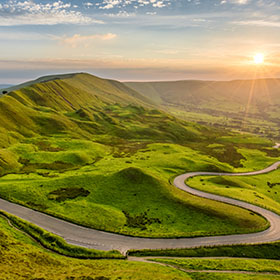 A winding road through a green hillside