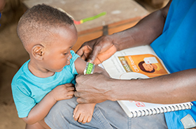 Child being assessed by CHAs in Liberia