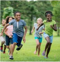 Children running on a grassy area